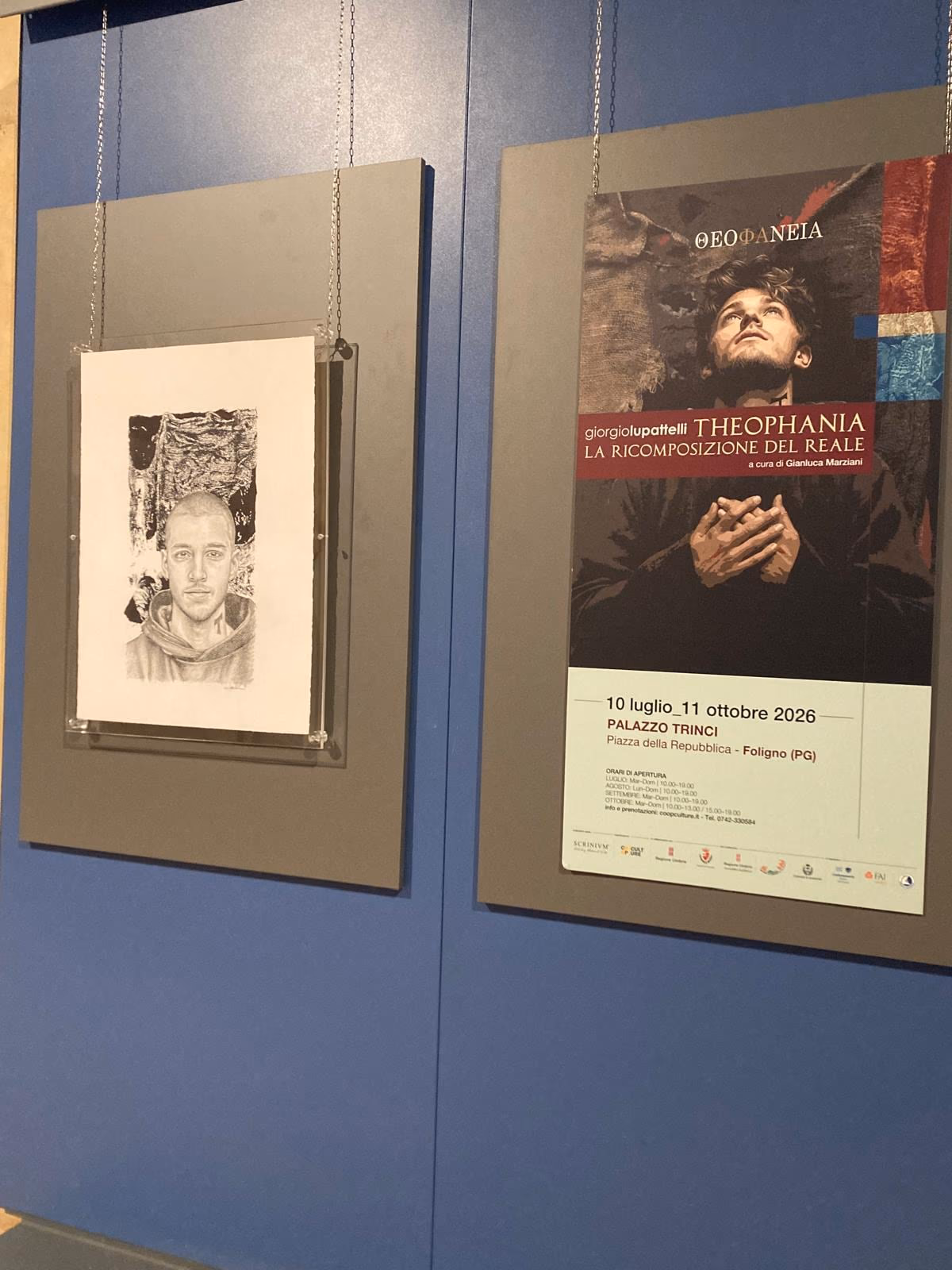A work and the THEOPHANIA poster on the entrance panel of the exhibition.